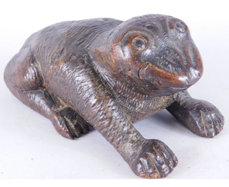 A carved wooden model, depicting a seated frog or toad, the reverse with sliding lid, carved with monkey or baboon, 18cm long
