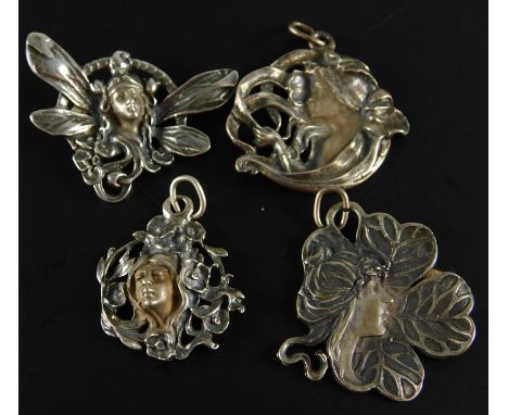 Three Art Nouveau style pendants, to include one of a lady with flowing hair, white metal stamped 925, another of a lady surr