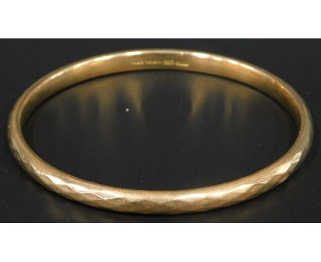 A bangle, marked 9ct gold metal core