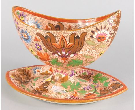 An early 19thC English creamware oval sauce tureen, printed and painted with flowers on a cell type ground, unmarked, possibl