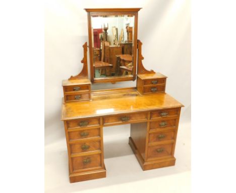 A Victorian mahogany dressing table, the rectangular bevel plate on shaped brackets with two pairs of trinket drawers, the ba