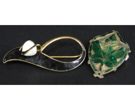 Two Norwegian enamel brooches, to include one in the form of a flower with white petals, on a black background, white metal s