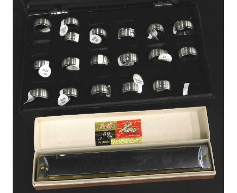 A quantity of modern stainless steel gent's rings, and a cased harmonica