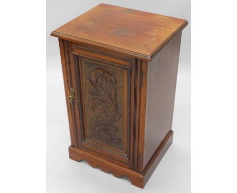 A Victorian walnut pot cupboard, with a carved panelled door, on bracket feet, 44cm wide