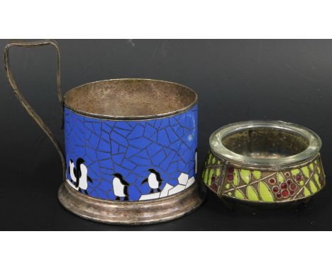 Two items of enamel, a Russian lommet salt decorated with berries and leaves, a cup holder with penguins