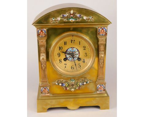 A late 19thC French brass and champleve enamel mantel clock, the arched case applied with foliate scroll decoration above a g