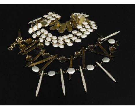 Two items of Scandinavian style enamel set jewellery, to include a brass necklace with white enamel and a silver and enamel t