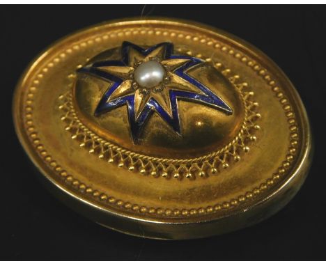 A Victorian oval bar brooch, with raised central oval design with blue enamel star, with faux seed pearl to centre, filigree 