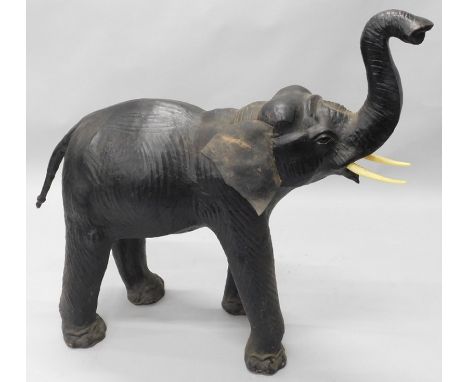 A large leather covered model of an elephant, with later tusks, 130cm long