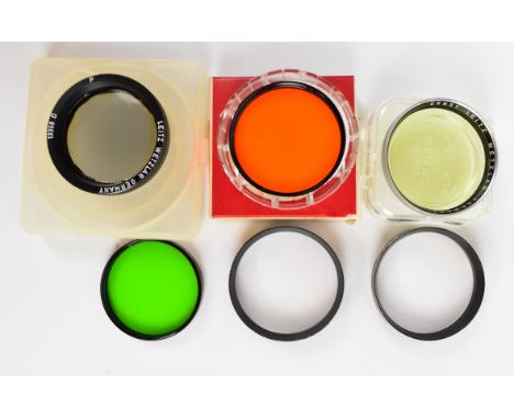 Four Leitz camera lens filters comprising 13358D, green and orange 5.5 series IV filters with 14160 clamping rings and a Summ