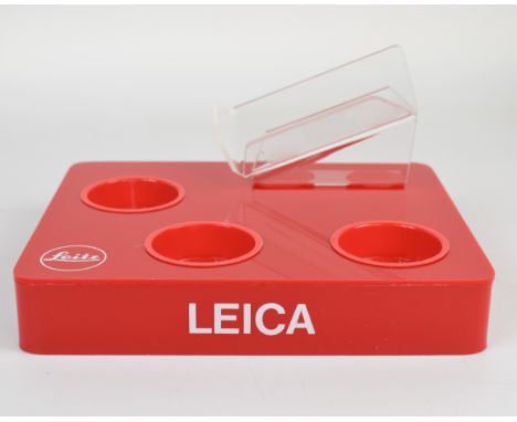 Leica plastic retail display stand to suit a camera body and three lenses, with Leitz name and reference number to underside 