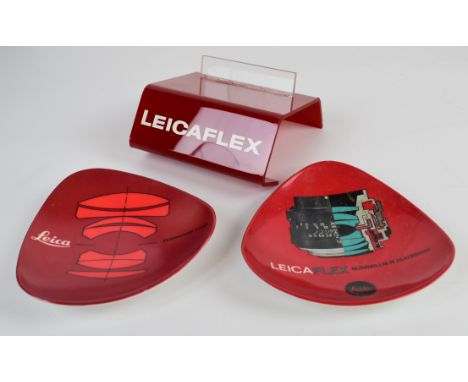Leica Leicaflex camera plastic retail display stand marked made in Germany to rear, width 12cm, together with two dishes, one