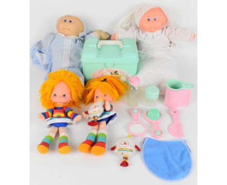 Four 1980s children's dolls comprising Rainbow Brite and Cabbage Patch Kids, together with accessories.
