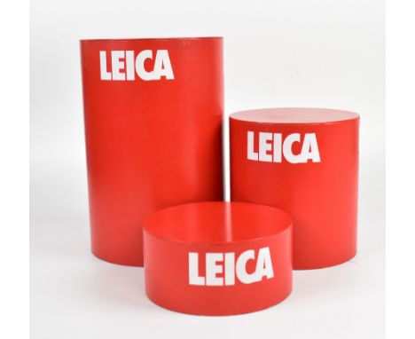 Graduated set of three Leica camera retail display stands, the smaller two sliding inside the larger for storage and shipping