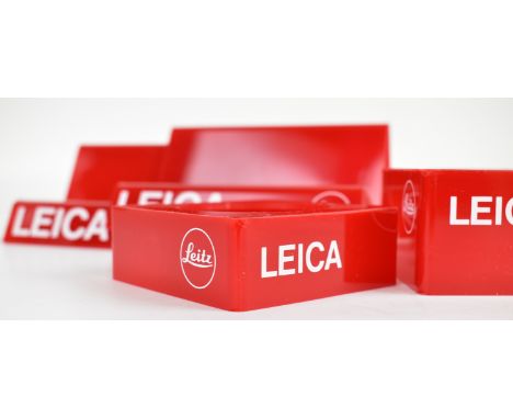 Four Leica camera plastic retail display stands, comprising two camera body stands with Leitz name and reference 940160 to re