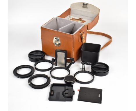 Hasselblad accessories comprising leather case, 100-250 lens hood, three focus handles, 63 and 50mm mount rings, winder knob,