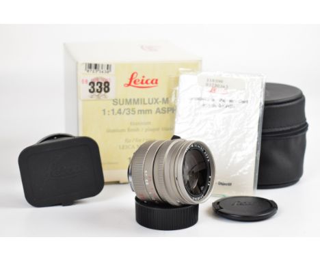 Leica Summilux-M M mount 1:1.4/35 ASPH camera lens with titanium finish, serial number 3730343 circa 1996 and Leica front and