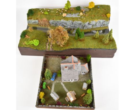 A pair of model countryside dioramas comprising modern farmhouse and riverbank scenes, largest 61x37cm, both housed in wooded