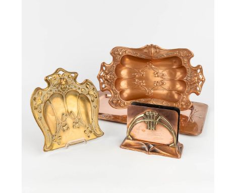 A collection of trays and table accessories made of copper in art nouveau style. One piece marked WMF. The first half of the 