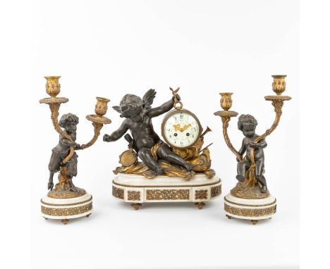 A three-piece mantle garniture, consisting of a clock with 2 candelabra made of spelter and marble. Decorated with putti and 