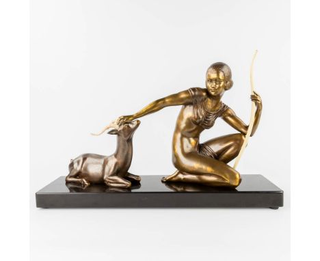 Kowas, Lady with a deer, a statue made in art deco style. Spelter and marble. The first half of the 20th century.  Dimensions