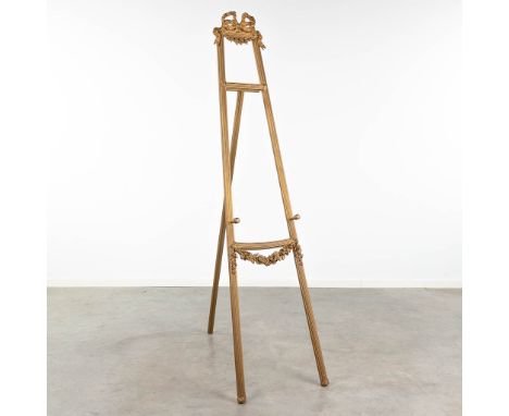 An easel made of sculptured and giltwood, decorated with garlands. Circa 1900. Dimensions: (W:50 x H:190 cm)