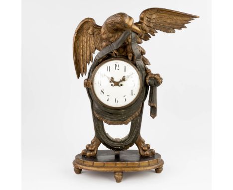 An antique gilt and patinated wood sculptured mantle clock with an eagle figurine. 19th century. Silk rope suspension and hal