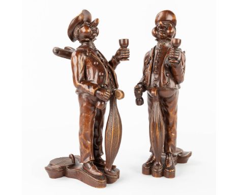 A pair of wood sculptured and figurative bottle holders. The first half of the 20th century.  Restorations and missing pieces