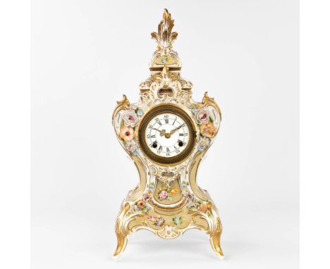 A mantle clock made of porcelain in rococo style with flower decor. 20th century.  Restoration to the top. Dimensions: (H:49 