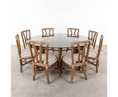 McGuire Furniture company, a large round dining room table with 8 chairs. Made of bamboo with a glass top. Circa 1980.   Over