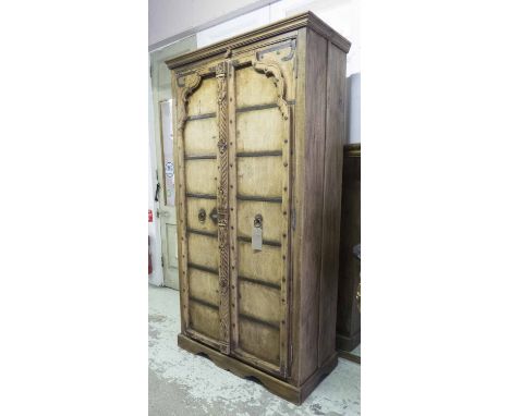 HALL CUPBOARD, vintage Indian carved hardwood, with two heavy doors enclosing double hanging space, 213cm H x 114cm x 55cm D.