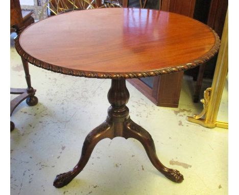 TRIPOD TABLE, George III mahogany with a circular tilt top having a gadrooned border and bird cage on a fluted baluster turne