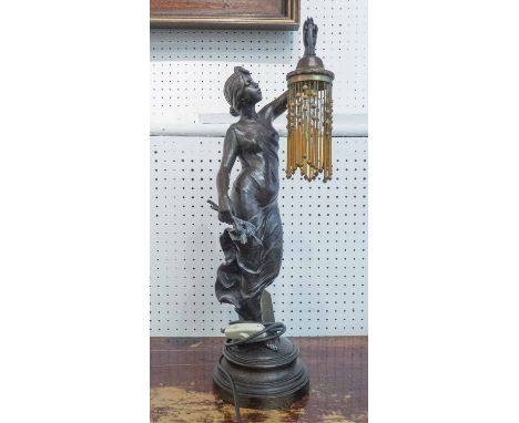 TABLE LAMP, of figural form, a maiden holding aloft a light, signed Villanio, 56cm H.