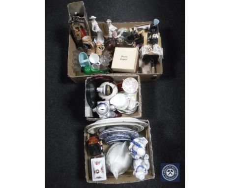 Three boxes containing novelty teapots, glassware, figurines, vintage soda siphon, china mantel clock, wall plates etc