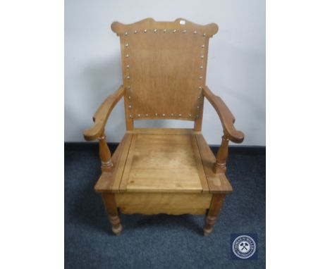 An early 20th century pine commode chair 