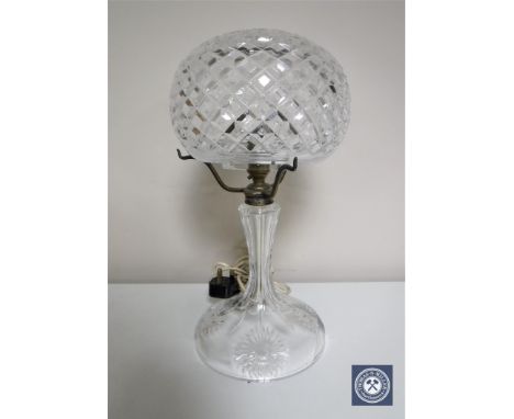 A cut glass table lamp with associated shade 