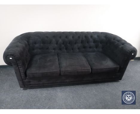 A black button dralon three seater Chesterfield style settee 