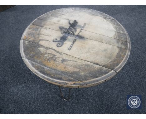 An oak barrel-topped coffee table with Old Smuggler Scotch Whisky advertising