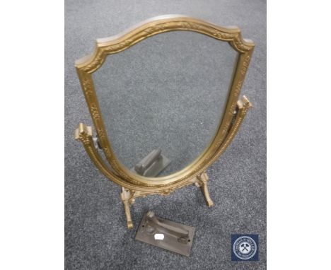 A gilt, shaped dressing table mirror together with a cast metal door knocker