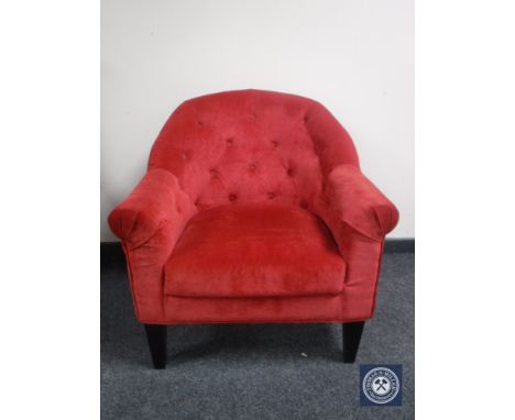 An armchair in red button dralon 