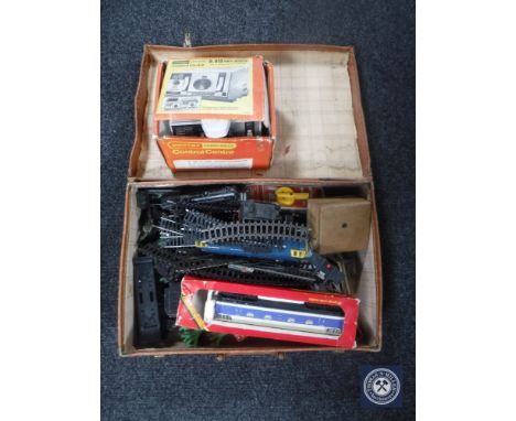 A vintage leather case containing Hornby rolling stock, track, power control unit etc