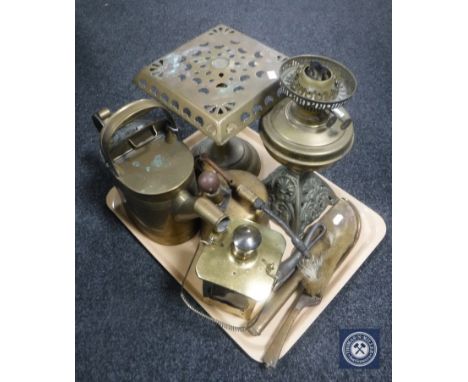 A tray of 20th century brass ware including an oil lamp base, brass trivet, watering can, crumb scoop and brush
