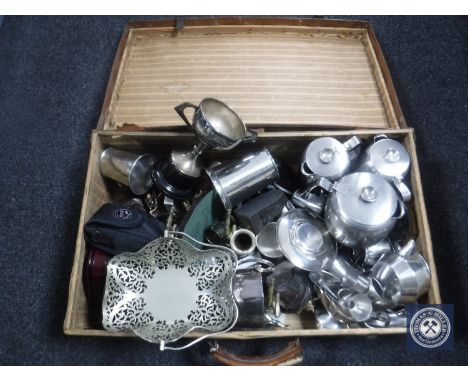 A vintage leather luggage case containing stainless steel and plated wares, trophies etc