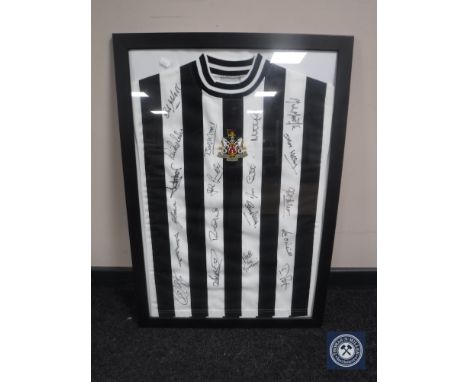 A singed framed NUFC vintage football shirt  CONDITION REPORT: These are genuine signatures, not printed. 