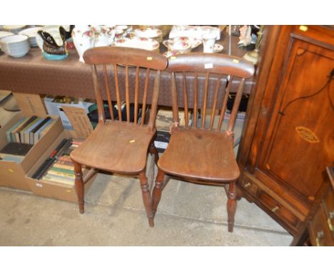 A pair of elm seated stick back chairs 