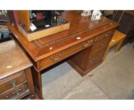 A reproduction mahogany desk with leather inset