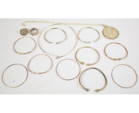 A collection of silver jewellery including two rings, ten bangles, mounted 25 dollar coin, chain and choker necklace, 280g