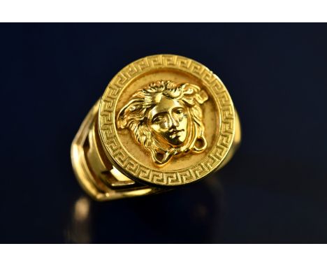 Versace 18ct gold ring depicting Medusa within a Greek key border and shoulders, 20.4g, size Z