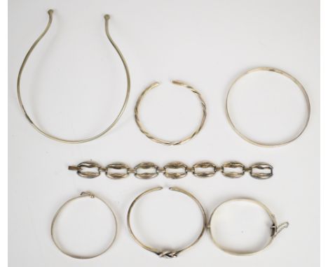 A collection of silver/ white metal jewellery including flapper bangle, knotted bangle, three other bangles, serpent choker/ 