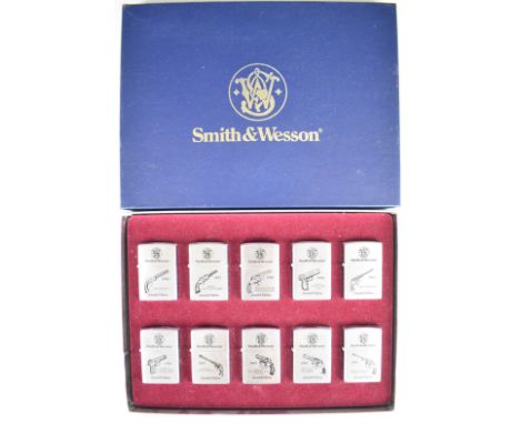 Ten Smith &amp; Wesson limited edition brushed chrome Zippo lighters, each with a different model pistol from 'The Original' 